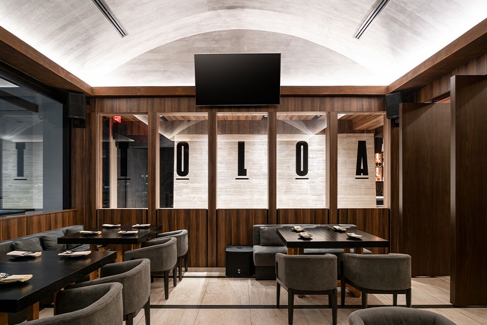 Toloa Rooftop interior — vaulted ceiling and walnut dining room