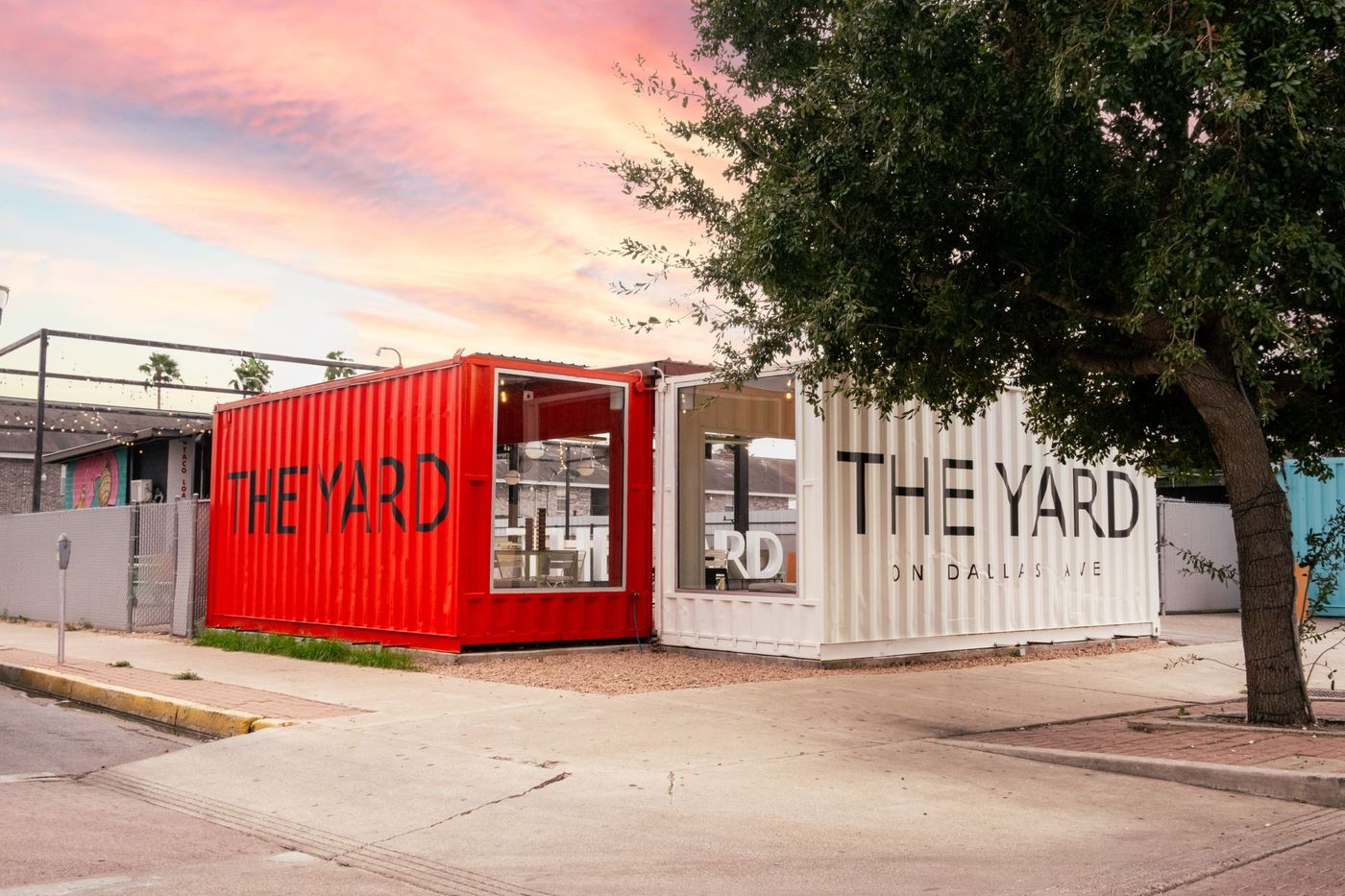 The Yard McAllen — large white THE YARD letters under string lights at sunset